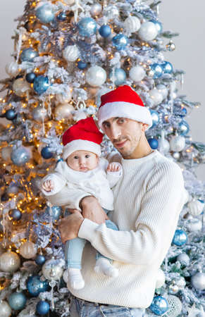 Christmas photo of a dad with a baby. Selective focus. Holiday.の写真素材