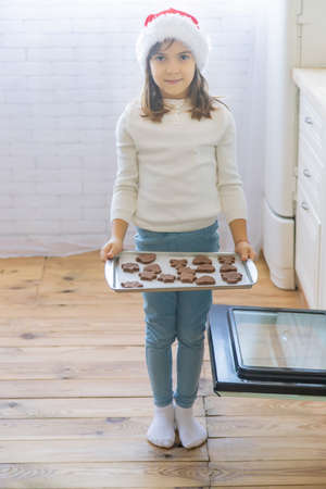 The child bakes and tastes Christmas cookies. Selective focus. holiday.の写真素材
