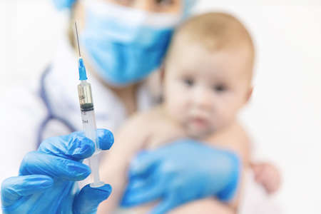 Vaccination of a baby by a doctor in a hospital. Selective focus. medicine.の写真素材