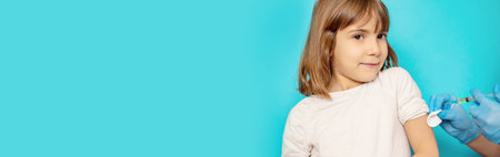 The child is injected into the arm. Selective focus.の写真素材