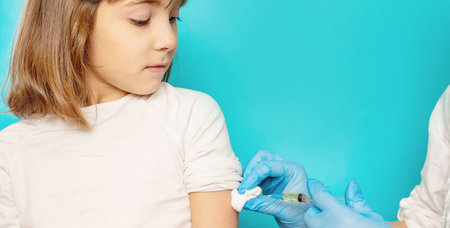 The child is injected into the arm. Selective focus.の写真素材