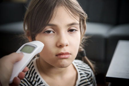 The mother measures the temperature of the child. Selective focus. People.の写真素材