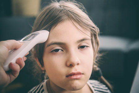 The mother measures the temperature of the child. Selective focus. People.の写真素材