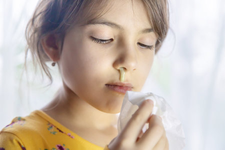 Snot in a child face close-up. Cold. Selective focus. People.の写真素材