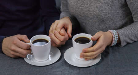 Man and woman at the table with a cup of coffee. Selective focus. People.