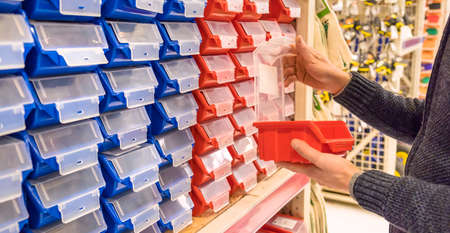 A man chooses an organizer box. Selective focus. People.の写真素材