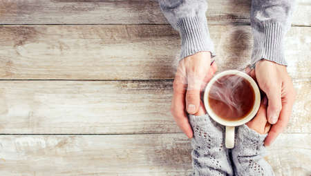 Cup drink for Breakfast in the hands of lovers. Selective focus. Nature.