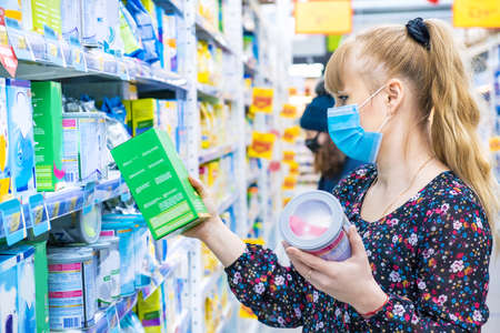 Woman chooses baby food in the store. Selective focus. Shop.の写真素材