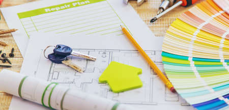 Paint palette house plan and repair tools. Selective focus. Color.