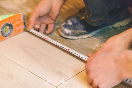 measure tile repair in the house. Selective focus. white.の写真素材
