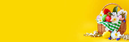 Happy Easter with flowers on a yellow background. Celebration. Selective focus. Holiday.