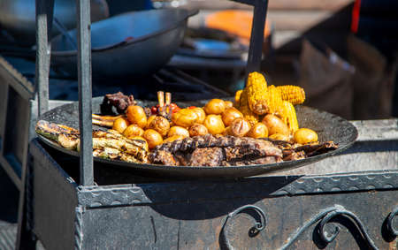 Barbecue and grilled vegetables are fried on the grill. Selective focus. Food.