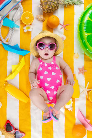 Baby on a beach towel at the sea. Selective focus. Child.の写真素材