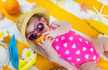 Baby on a beach towel at the sea. Selective focus. Child.の写真素材