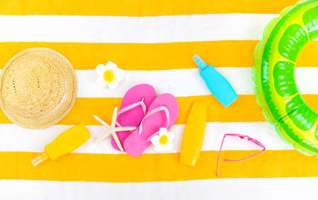 Beach towel with relaxation accessories. Selective focus. Sea.
