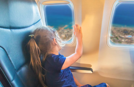 Child girl on the plane.の写真素材
