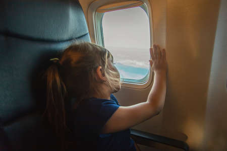 Child girl on the plane. Selective focus. Kid.