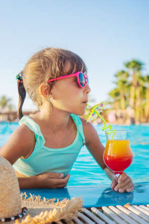 A child at the sea drinks a cocktail. Selective focus. Kid.の写真素材