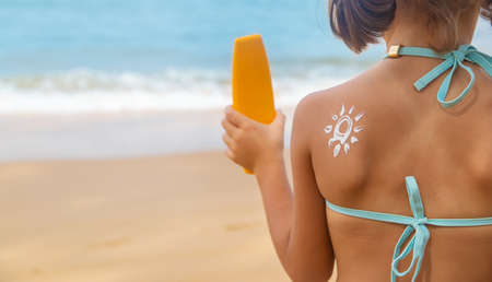 Child on the beach with sunscreen on his back. Selective focus. Travel.の写真素材