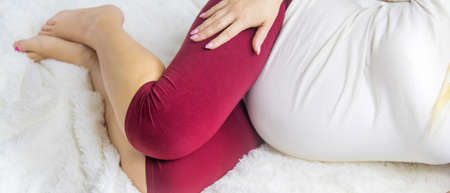 A pregnant woman hugs her belly. Selective Focus. people.の写真素材