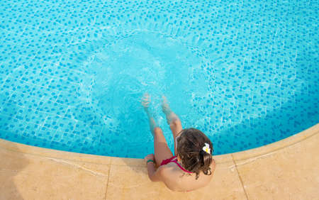 The child splashes water in the pool. Selective focus. People.の写真素材