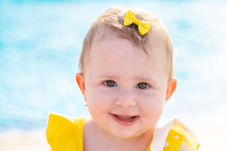 Baby near the pool is molded with water. Selective focus. People.の写真素材