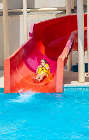 Children descend from the slides in the water park. Selective focus. Nature.の写真素材