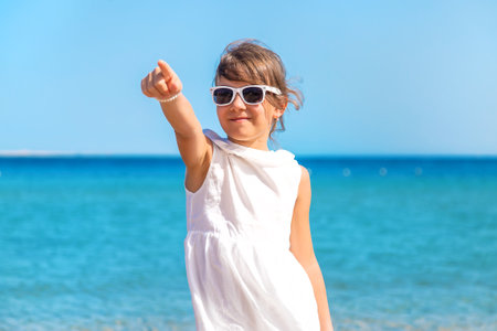 Child girl on the sea beach. Selective focus. Kid.の写真素材