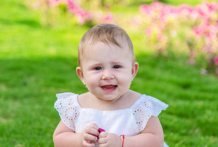 The girl's children are sitting under a palm tree. Selective focus. Nature.の写真素材