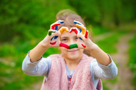 Smile on the hands of a child drawing. Selective focus. Kid.