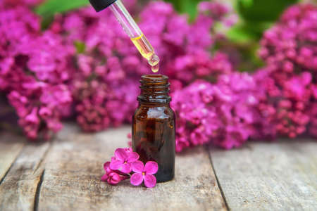 Lilac essential oil in a small bottle. Selective focus. Nature.の写真素材