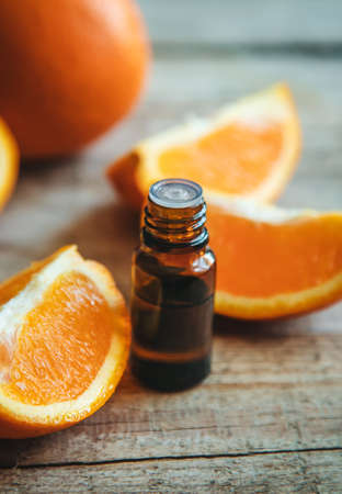 Orange essential oil in a small bottle. Selective focus. Food.の写真素材