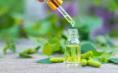 Birch bud extract in a small bottle. Selective focus. Nature.の写真素材