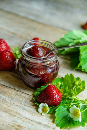 Homemade strawberry jam in a jar. Selective focus. Food.