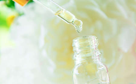 Tincture of peony extract in a pipette drop. Selective focus. Nature.の写真素材