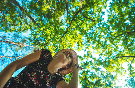 Sunny day trees and woman sky. Selective focus.の写真素材