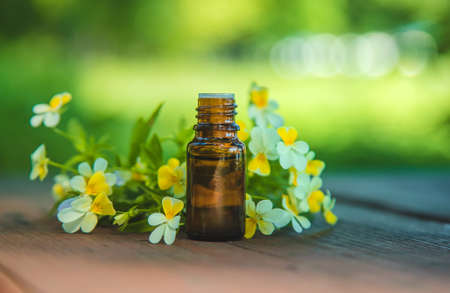 Violet essential oil in a small bottle. Selective focus. Nature.の写真素材