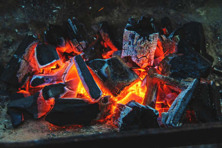 Coals are burning in the grill. Selective focus. fire.