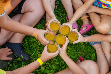 Children are drinking lemonade on the street together. Selective focus. Kids.の写真素材