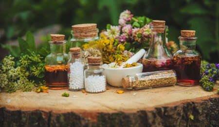 Tincture of medicinal herbs in bottles. Selective focus. Nature.の写真素材