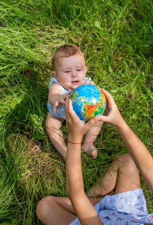 The child holds the globe in his hands. Selective focus. Nature.の写真素材
