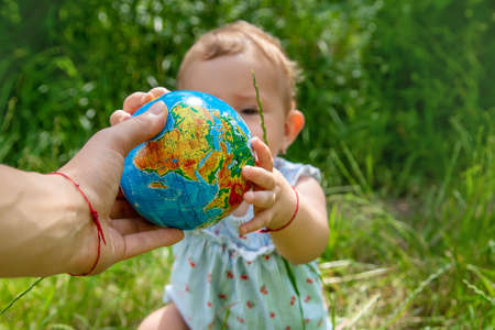 The child holds the globe in his hands. Selective focus. Nature.の写真素材
