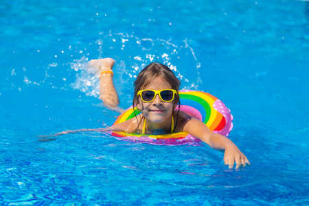 The child swims with a circle in the pool. Selective focus. Kid.の写真素材