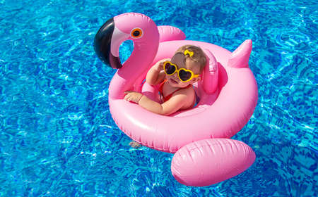 Baby swims in a circle in the pool. Selective focus. Nature.