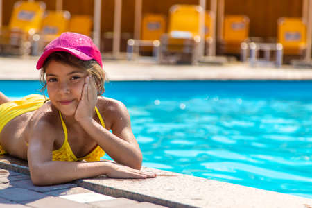 The child is swimming in the pool. Selective focus. Kid.