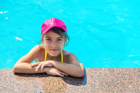 The child is swimming in the pool. Selective focus. Kid.の写真素材