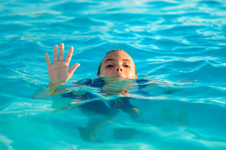 The child is drowning in water. Selective focus. Kid.