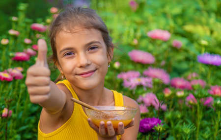 The child eats flower honey. Selective focus. Nature.の写真素材