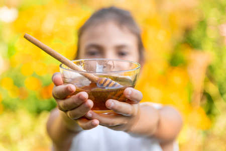 The child eats flower honey. Selective focus. Nature.