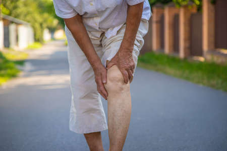 The grandmother has an old woman knee pain. Selective focus. Nature.の写真素材